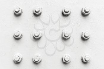 Abstract industrial background, white bolts and nuts