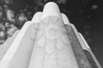 Abstract industrial architecture fragment, large concrete tanks for storage of bulk materials