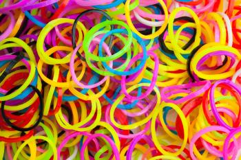 Macro photo texture of small round colorful rubber bands for making rainbow loom bracelets