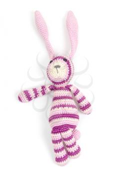 Funny knitted rabbit toy showing left direction isolated on white background with soft shadow