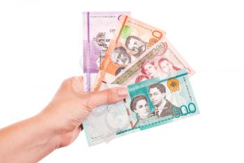 Dominican Republic money in female hands, closeup studio photo isolated on white