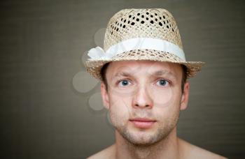 Young man in a fun straw hat