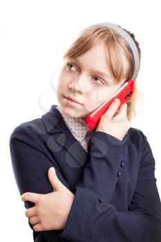 Caucasian schoolgirl calling by mobile phone on white background