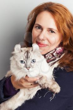 Portrait of beautiful smiling Young Caucasian woman with white cat