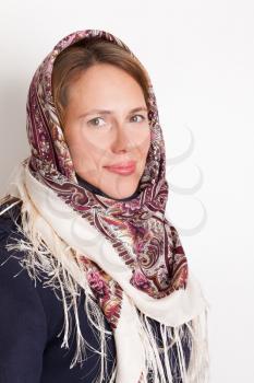 Portrait of smiling Young Caucasian woman in traditional Russian Pavloposadskie scarf on head