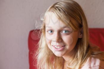 Closeup face portrait of beautiful blond smiling Caucasian girl