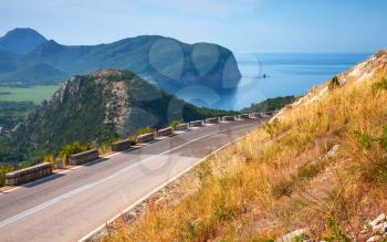 Summer mountain road with blue sky and sea on a background. Adriatic sea coast, Montenegro