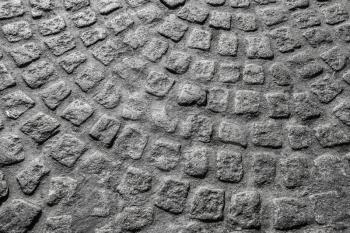 Background photo texture. Gray granite cobblestone road pavement