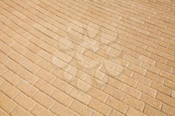 Background texture of yellow cobblestone pavement pattern