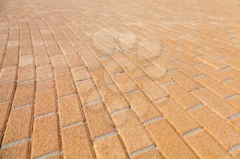 Background texture of urban yellow cobblestone pavement