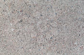 Gray urban pavement with small stones, closeup background texture
