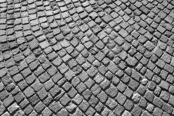 Gray granite cobblestone road pavement with round pattern. Background photo texture