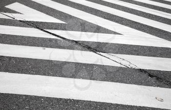 Dark gray asphalt road with pedestrian crossing road marking zebra, abstract transportation background