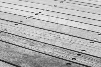 Gray wooden floor made of boards with bolts, background photo texture with selective focus