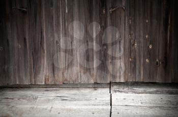 Old dark grunge interior background with weathered wooden wall and floor