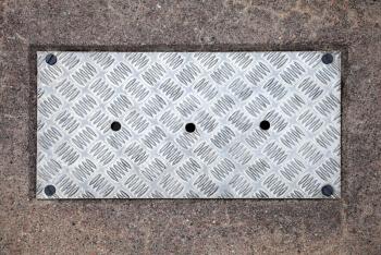 Closeup texture of diamond metal panel with holes