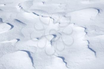 Background texture of hilly snowdrift with nice curved shadows