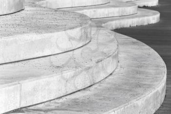 Abstract concrete interior fragment, curved stairs. Photo with selective focus