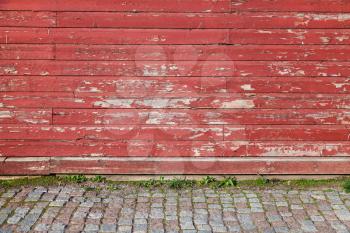 Empty abstract interior background with old red wooden wall and cobblestone floor