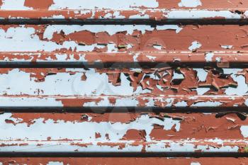 Old metal wall with peeling paint layers, grungy background texture