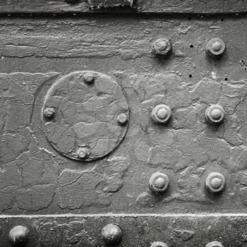 Square abstract dark gray industrial metal background texture with bolts and rivets