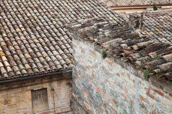 Old roofs in Fermo, Italy. Stone living houses exterior