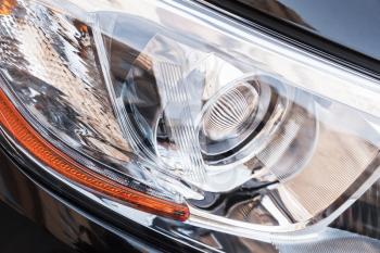 Modern shining car headlight with LED lamps, close up photo with selective focus