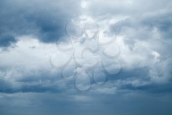 Dark sky with blue stormy clouds, natural background photo texture