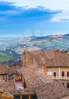 Fermo, Italy. Vertical photo with old tiling roofs of stone living houses