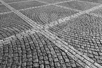 Gray cobblestone street pavement with square pattern, urban background texture 
