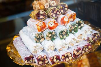 Assortment of Turkish delight on the counter. Traditional cuisines of the former Ottoman Empire and the Middle East. Photo with selective focus