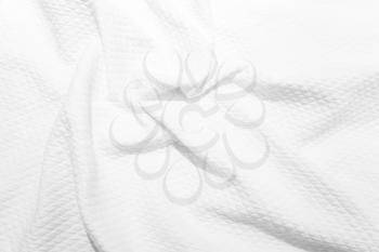 White cotton fabric texture, background photo of crumpled blanket, selective focus