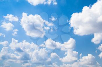 Cumulus clouds in bright blue sky at daytime, natural background photo