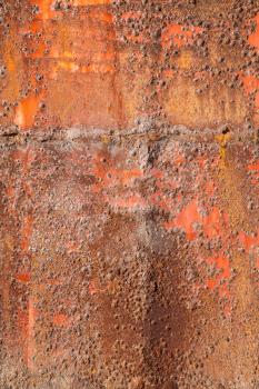 Old red rusted iron plate, vertical background photo texture