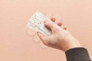 Male hand holds plastic door key cards with holes combination code