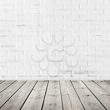 Gray wooden floor and white brick wall with plastering. Abstract square interior background