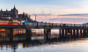 Evening cityscape with Metro train on the bridge of Gamla Stan, Stockholm, Sweden
