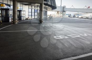 Bus stop in European airport, road marking near passenger terminal