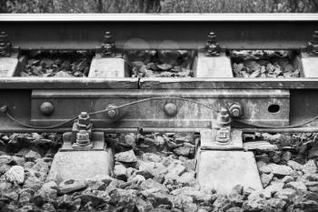 Railway details, rails joint with gap, closeup black and white retro style photo with selective focus