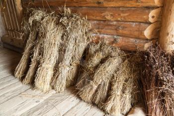 Hay sheaves in old wooden barn interior, rural Russian objects