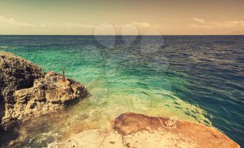 Coastal rocks of Greek island Zakynthos in the Ionian Sea. Vintage toned photo, old style filter effect
