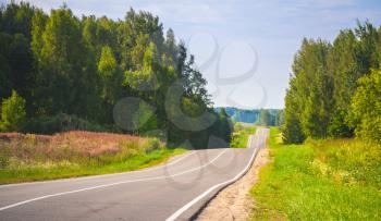 Empty rural highway in summer day, European road landscape with selective focus and shallow DOF