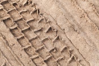 Tire track on wet sand, abstract transportation background texture