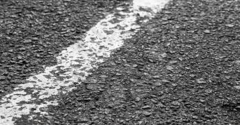 White dividing line on tarmac, highway road marking. Abstract transportation background
