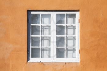 Square window in white wooden frame, yellow wall background photo texture 