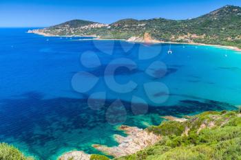 Coastal landscape of South Corsica. Small azure bay with yachts, Piana region, France