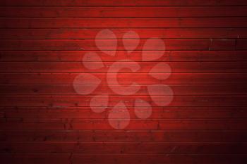 Red rural wooden wall, close-up background photo texture with spot light illumination effect