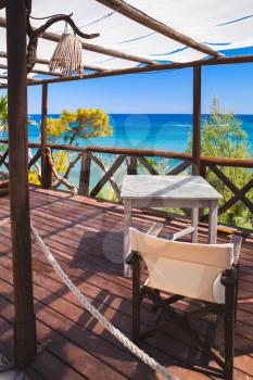 Seaside balcony with wooden furniture, popular touristic Greek resort island Zakynthos