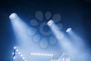 Spot lights with blue rays in the dark, stage illumination equipment