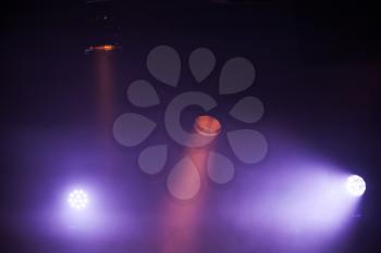 Colorful spot lights with strong beams in dark fog, stage illumination background photo